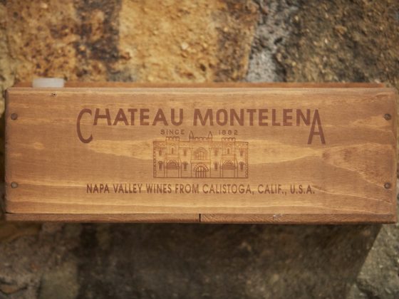Close up of wooden wine box against stone wall
