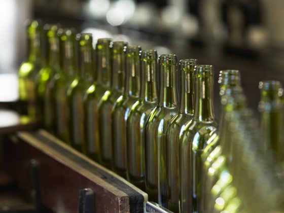 Assembly line of empty glass bottles
