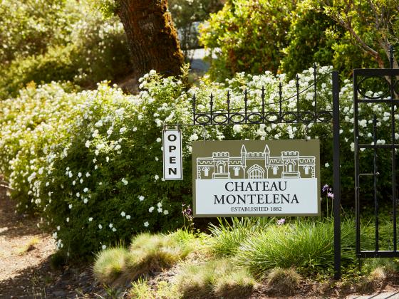 Front gate with Chateau Montelena sign hanging from it. A small white sign is flipped to read "Open."